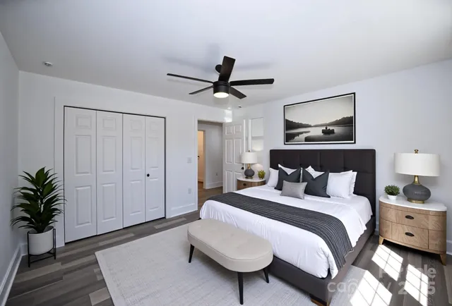 a bedroom with a bed and a potted plant