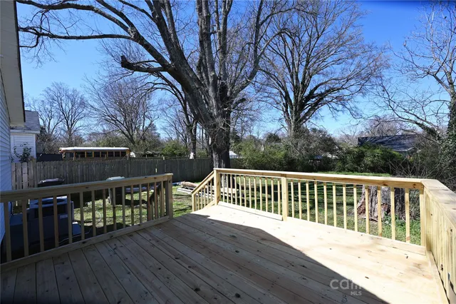 a deck with wooden floor and fence