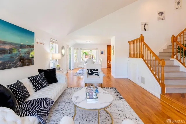 a kitchen with stainless steel appliances granite countertop a stove a sink and living room view