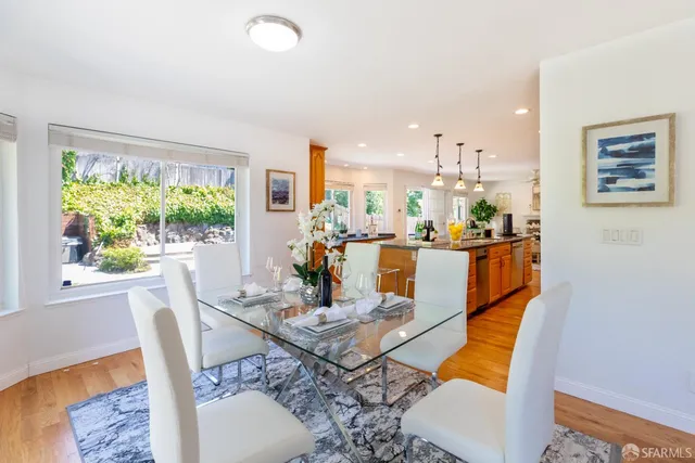 a view of a kitchen with kitchen island granite countertop a large counter top stainless steel appliances and cabinets