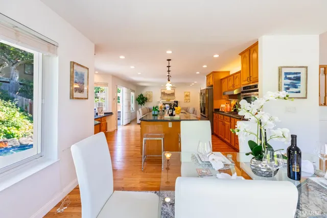 a living room with furniture a large window and a fireplace