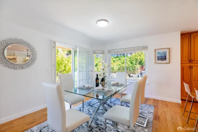 a living room with furniture ceiling fan and a large window