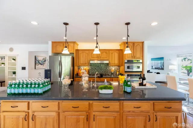 a living room with furniture a large window and a fireplace