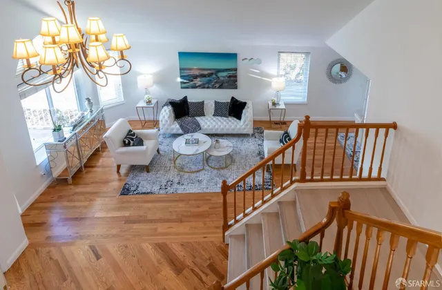 a view of a hallway with wooden floor and stairs