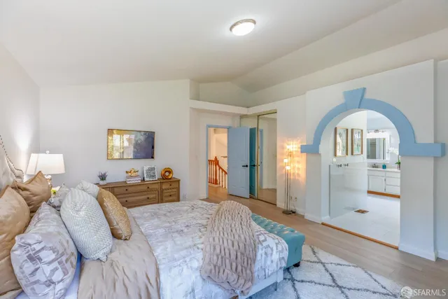 a bedroom with a bed and a chandelier