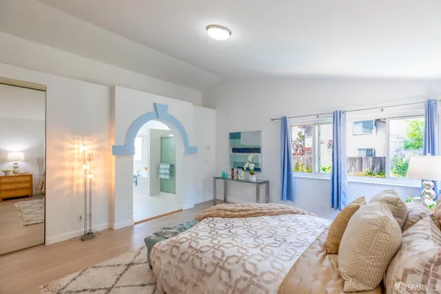 a bedroom with a bed and a window