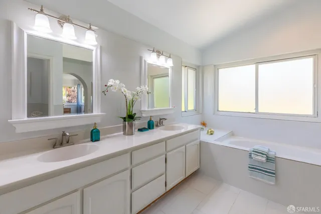 a bedroom with a bed and a lamp on dresser