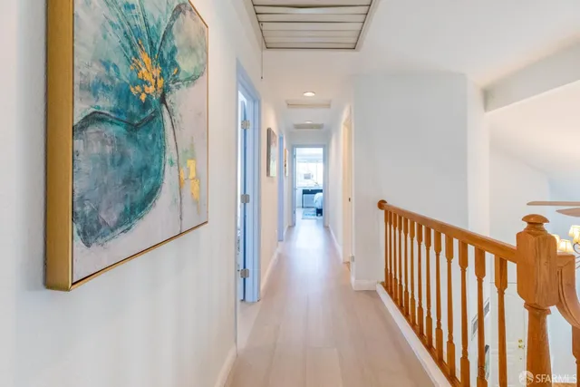 a living room with patio furniture and a potted plant