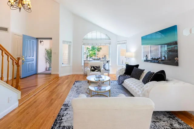 a dining room with furniture a large window and a rug