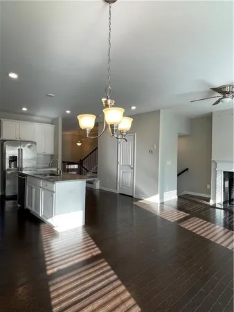 a view of a kitchen with dining table chairs wooden floor and a view of kitchen