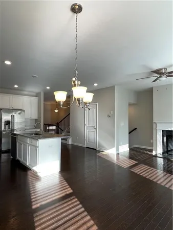 a view of a kitchen with granite countertop stainless steel appliances and wooden floor