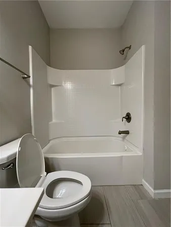 a bathroom with a toilet and a bathtub