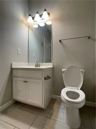 a bathroom with a toilet sink and a mirror
