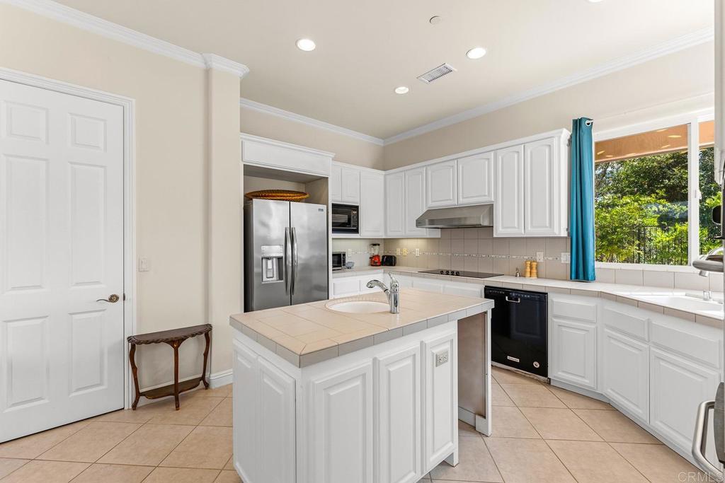 2557 Live Oak Park Road Fallbrook, CA 92028 - Photo 11 of 53 a kitchen with a sink a stove a refrigerator and cabinets