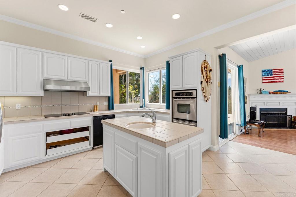 2557 Live Oak Park Road Fallbrook, CA 92028 - Photo 14 of 53 a kitchen with a refrigerator stove top oven and sink