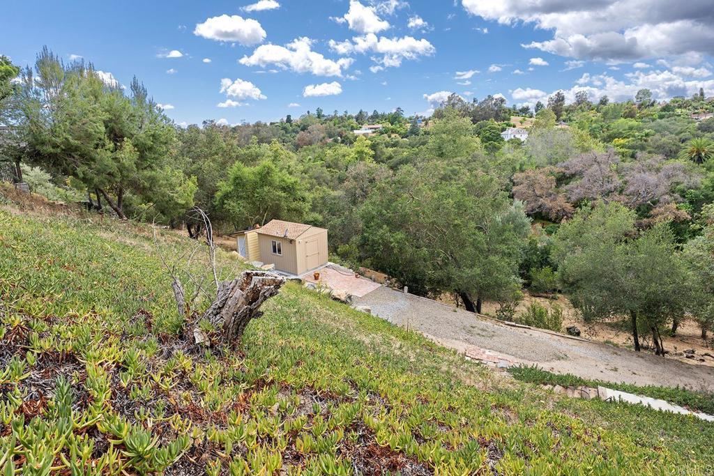 2557 Live Oak Park Road Fallbrook, CA 92028 - Photo 42 of 53 a view of a house with a yard and garden