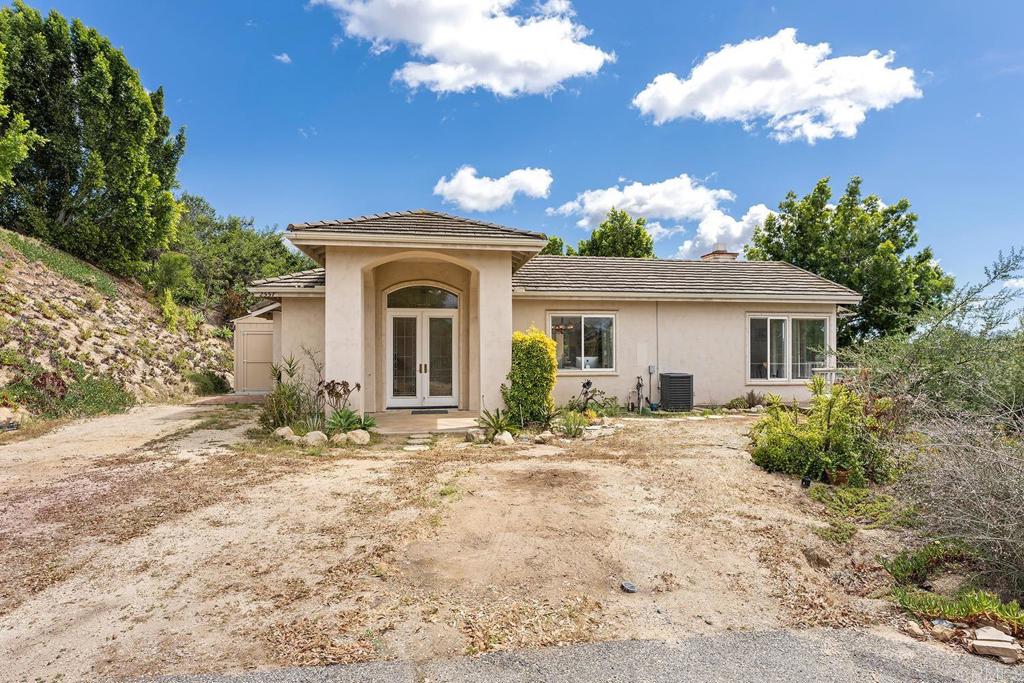 2557 Live Oak Park Road Fallbrook, CA 92028 - Photo 5 of 53 a front view of a house with a yard