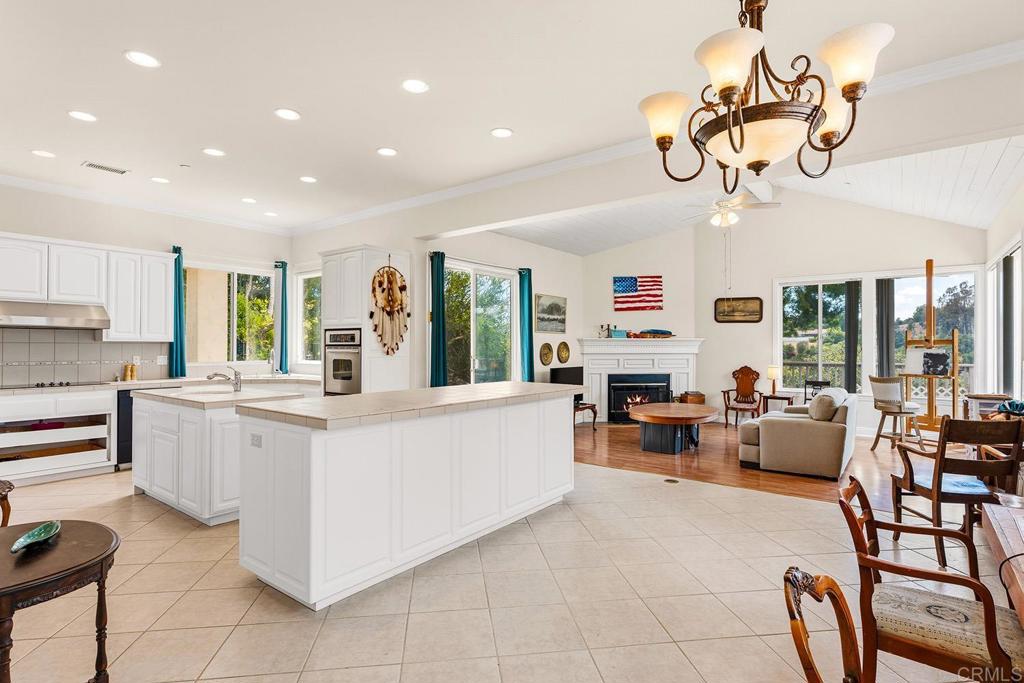 2557 Live Oak Park Road Fallbrook, CA 92028 - Photo 7 of 53 a large white kitchen with a large window appliances and furniture