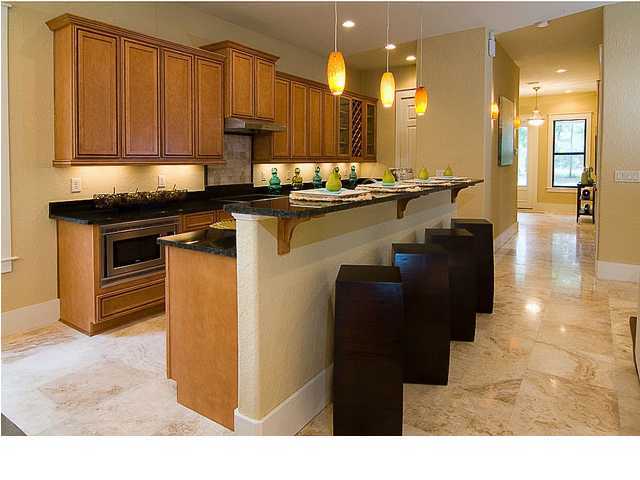 31 Beacon Point Drive Santa Rosa Beach, FL 32459 - Photo 6 of 18 a kitchen with kitchen island granite countertop a sink cabinets and stainless steel appliances