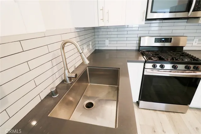 a kitchen with a sink and a stove