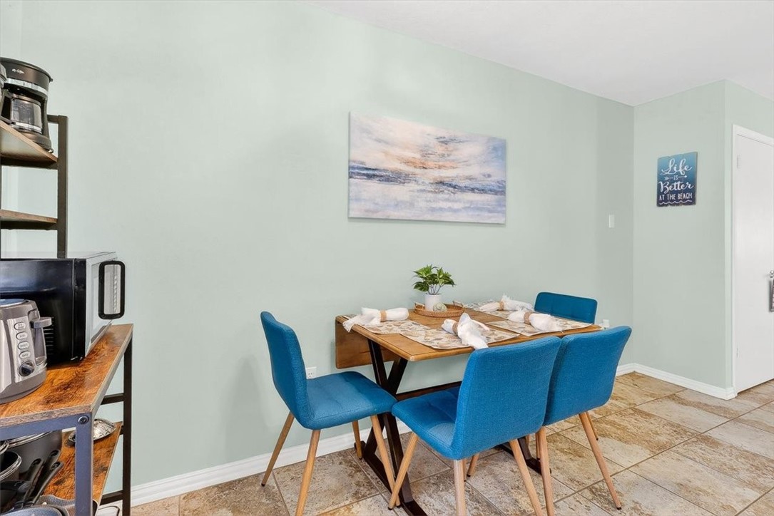 622 Beach Access Road, Unit 216 Port Aransas, TX 78373 - Photo 12 of 32 a dining room with furniture and wooden floor