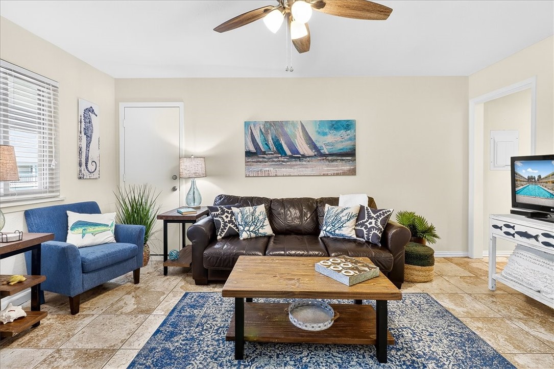 622 Beach Access Road, Unit 216 Port Aransas, TX 78373 - Photo 14 of 32 a living room with furniture a rug and a flat screen tv