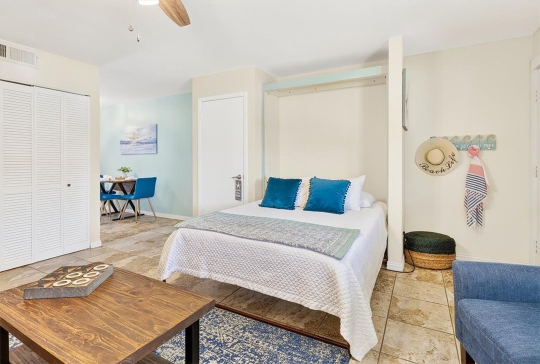 622 Beach Access Road, Unit 216 Port Aransas, TX 78373 - Photo 18 of 32 a bedroom with a bed and wooden floor