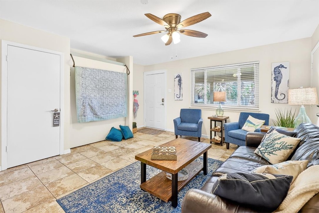 622 Beach Access Road, Unit 216 Port Aransas, TX 78373 - Photo 4 of 32 a living room with furniture a table and a large window