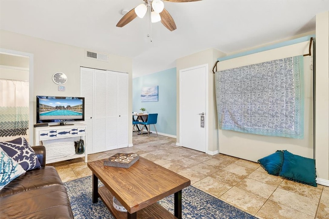 622 Beach Access Road, Unit 216 Port Aransas, TX 78373 - Photo 5 of 32 a living room with furniture and a flat screen tv