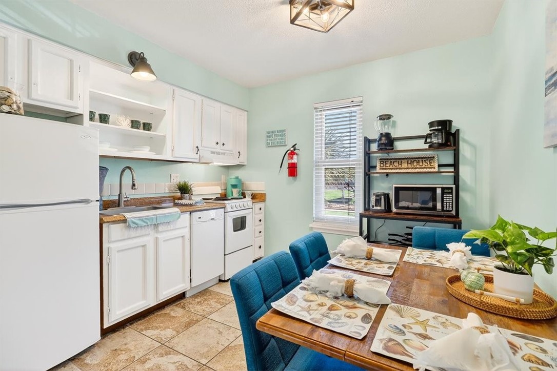 622 Beach Access Road, Unit 216 Port Aransas, TX 78373 - Photo 8 of 32 a kitchen with a refrigerator and a stove top oven