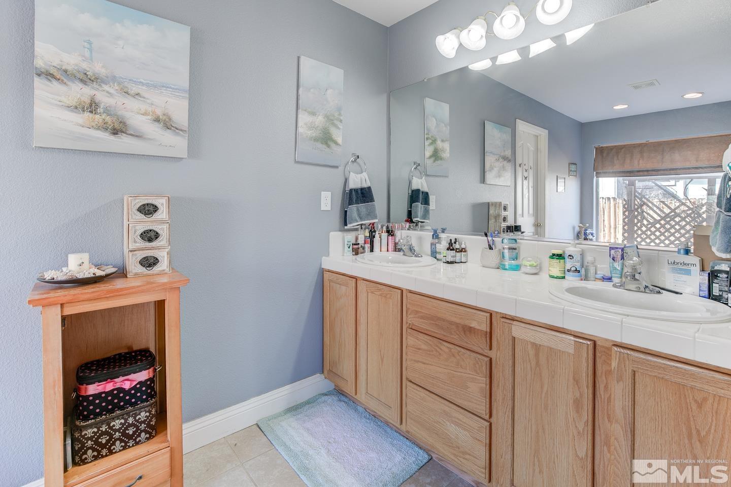 437 Rio Vista Drive Fallon, NV 89406 - Photo 12 of 24 a bathroom with a sink and a mirror