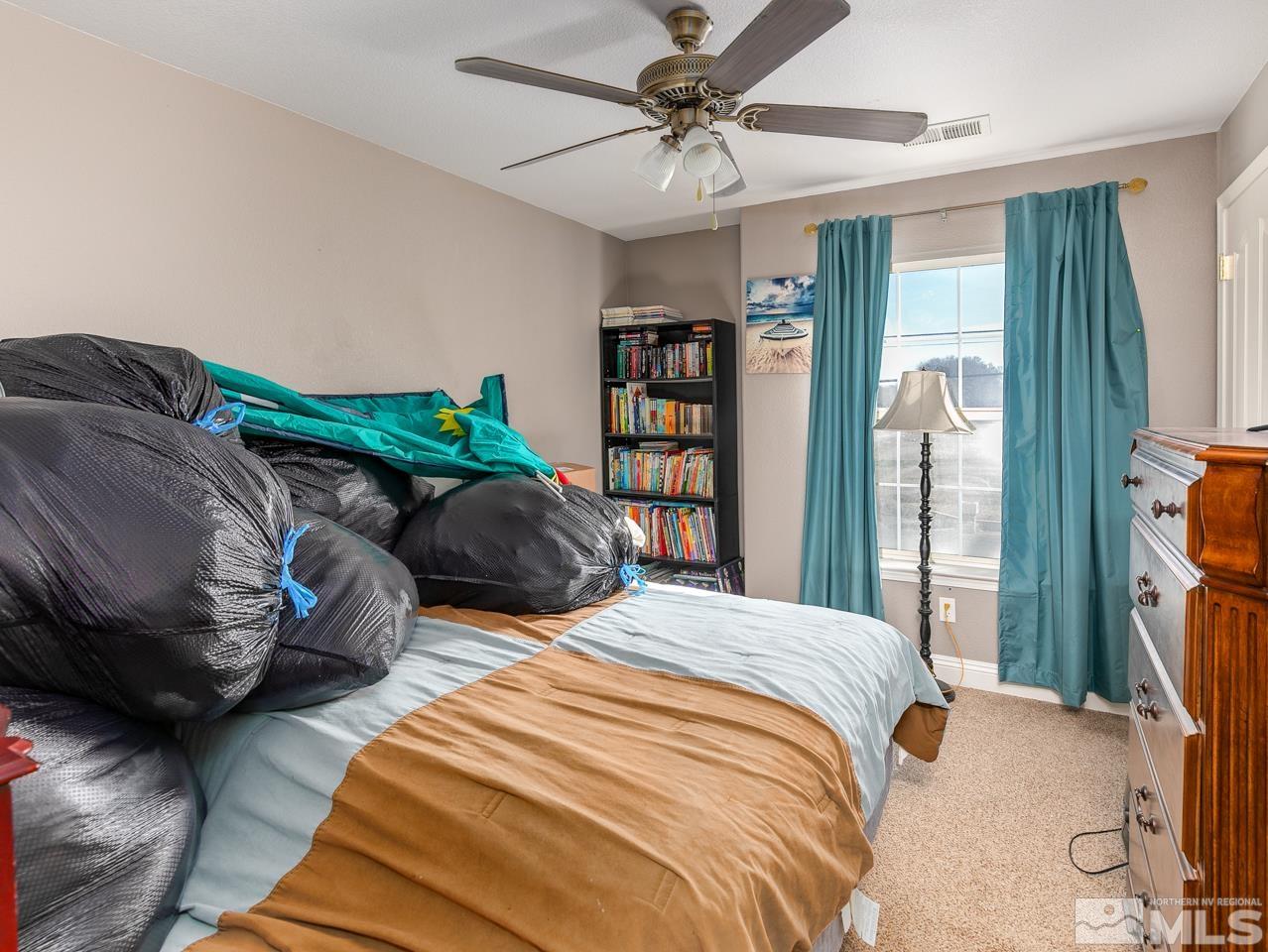 437 Rio Vista Drive Fallon, NV 89406 - Photo 17 of 24 a bedroom with bed and a window