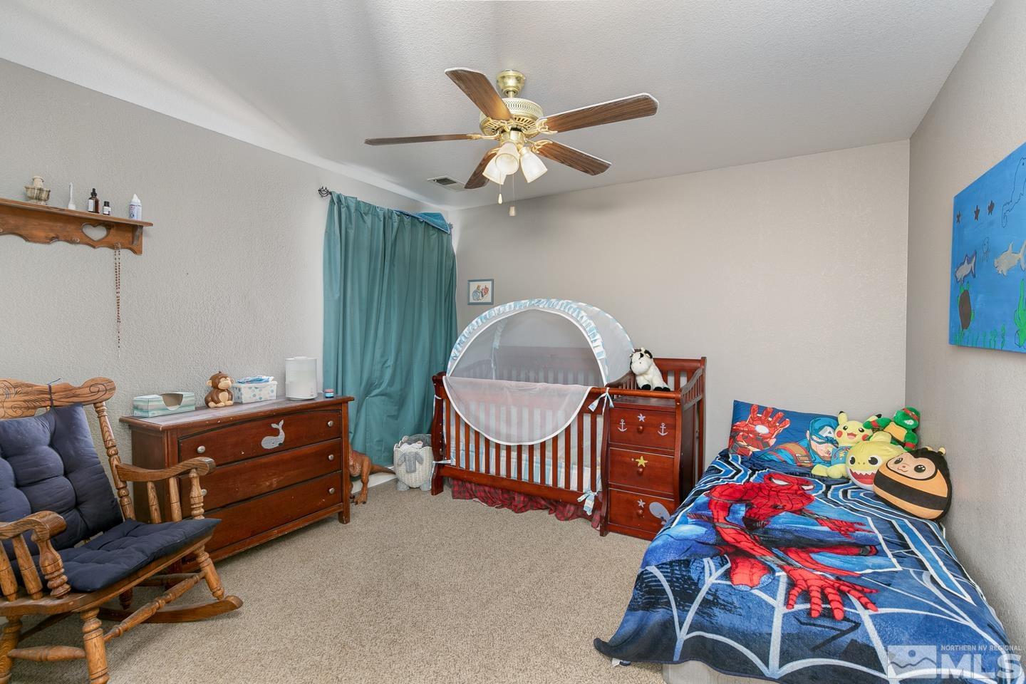 437 Rio Vista Drive Fallon, NV 89406 - Photo 18 of 24 a bedroom with furniture and a wooden floor