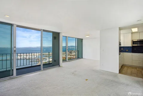 a dining room with furniture and a large window