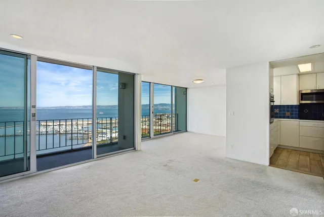 a dining room with furniture and a large window
