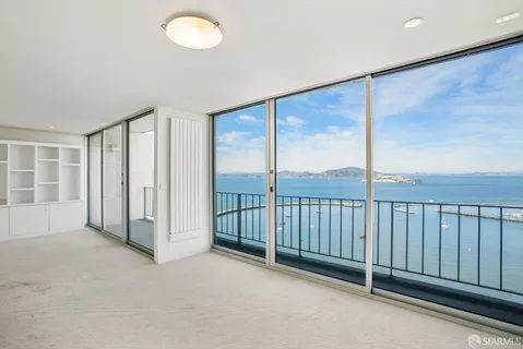 a kitchen with stainless steel appliances a stove microwave and sink