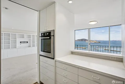 a kitchen with stainless steel appliances a microwave a sink and cabinets