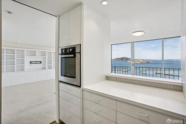 a kitchen with stainless steel appliances a microwave a sink and cabinets