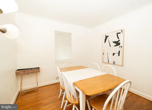 a dining room with furniture and wooden floor
