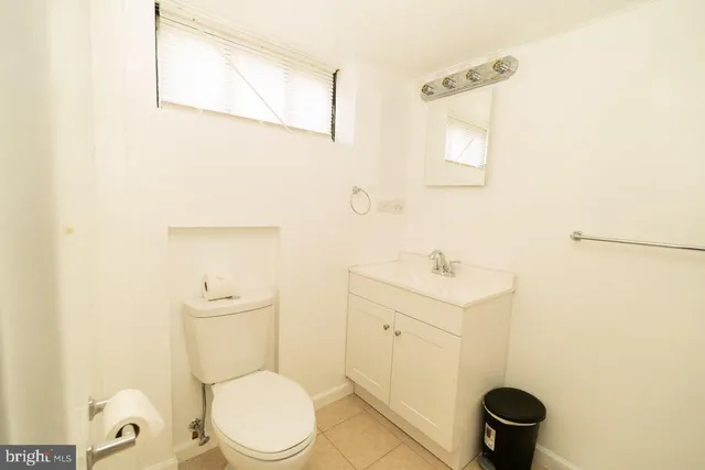 a white toilet sitting next to a bathroom sink