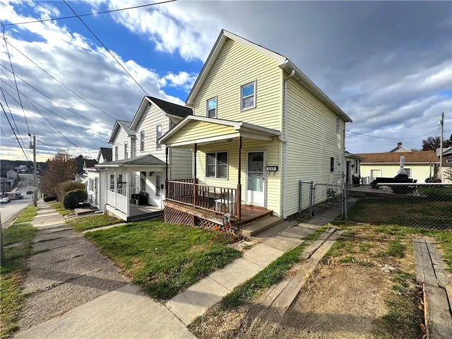 a view of a house with tub next to a yard