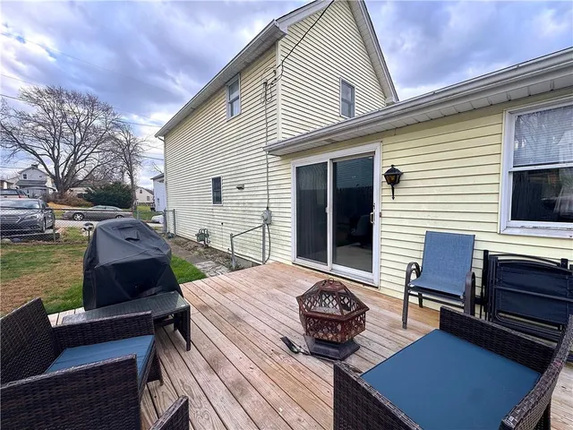 a view of a patio with couches chairs and wooden floor