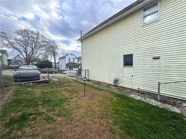 a backyard of a house with table and chairs
