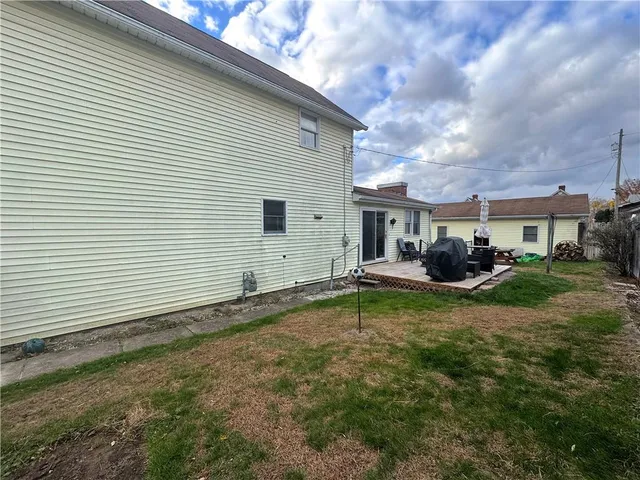 a backyard of a house with table and chairs