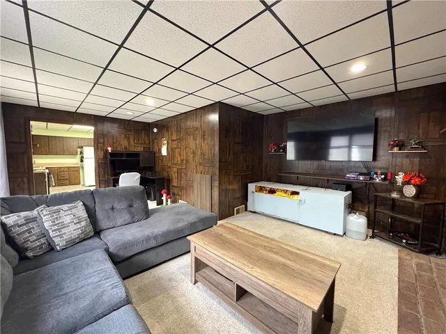 a living room with furniture and a chandelier