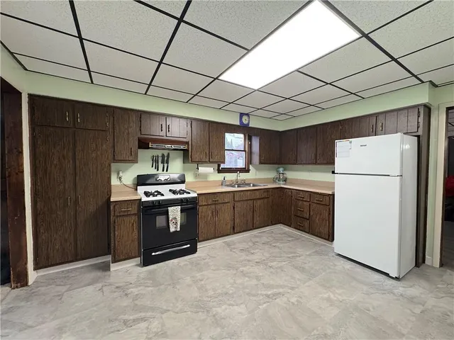a kitchen with furniture and refrigerator