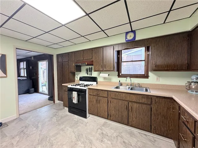 a bathroom with a granite countertop sink a toilet and a mirror