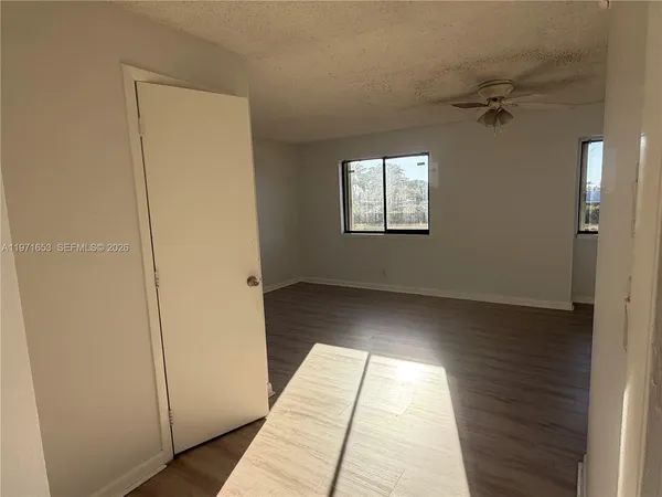 a view of an empty room and a window