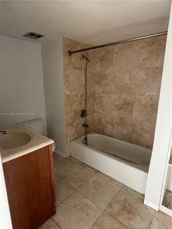 a bathroom with a sink a bath tub and a shower