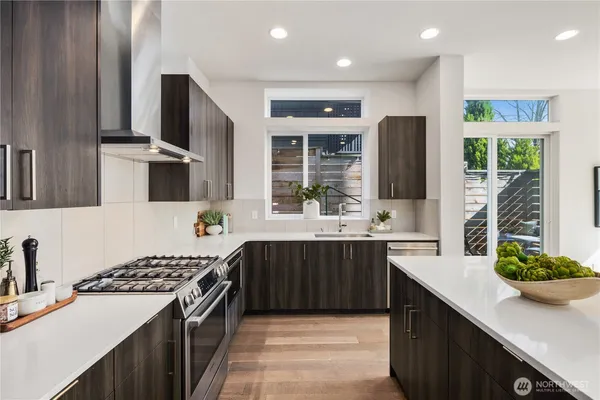 a kitchen with stainless steel appliances a sink stove and refrigerator